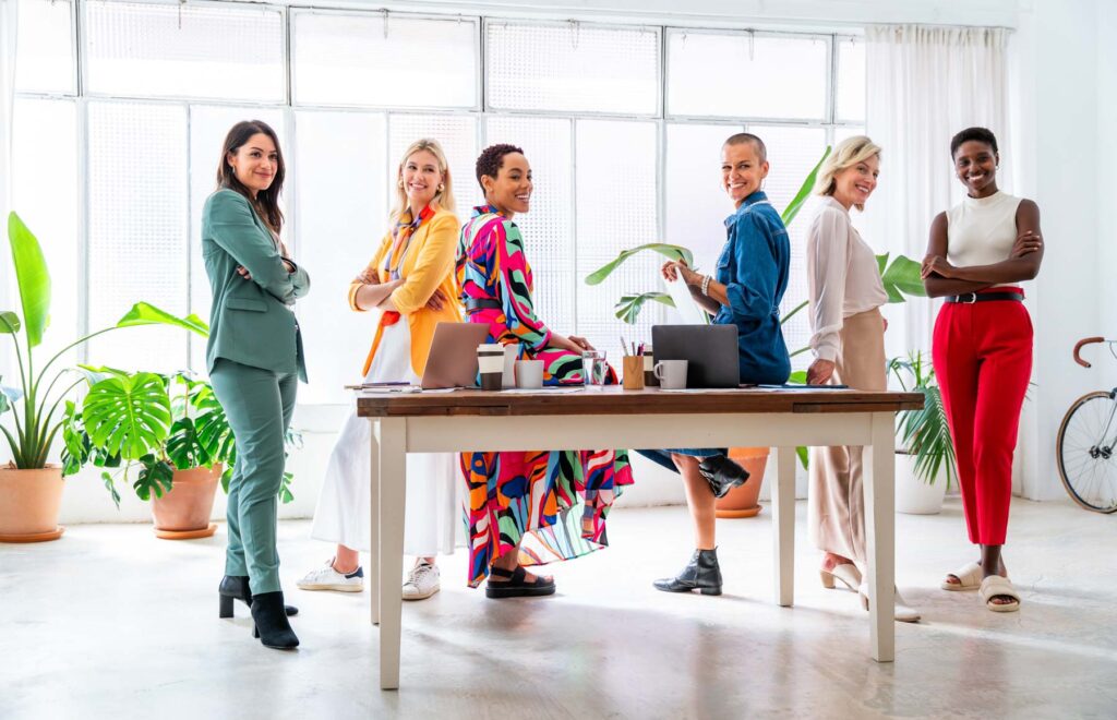 Group of beautiful confident businesswomen meeting in the office - Multiethinc female creative team brainstorming at work - Diverse colleagues working together  in workshop  in a co-working space
